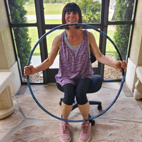 Hula hoop exercise for a low-functioning adult, seated