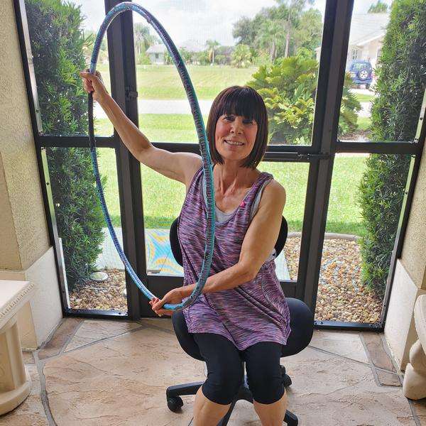 Hula hoop exercise for a low-functioning adult, hands on hoop
