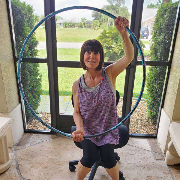 Hula hoop exercise for a low-functioning adult, in progress